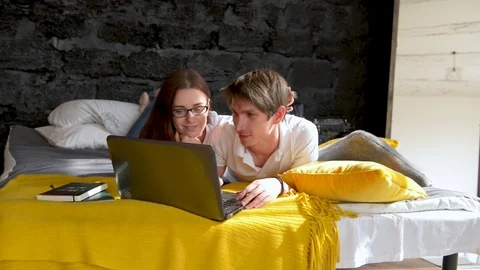 Couple Lying In Bed Use Laptop Computer Happy Smile Chatting Online, Young Girl Stock Footage 75847048