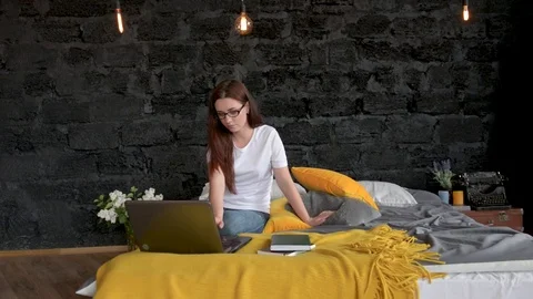 Couple Lying In Bed Use Laptop Computer Happy Smile Chatting Online and eating Stock Footage 75847168