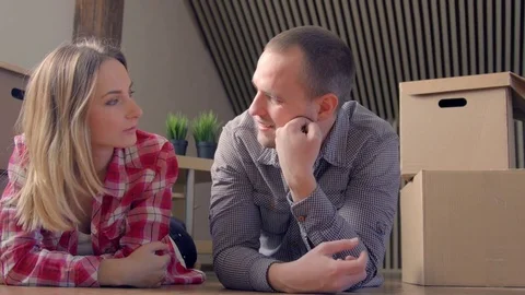 Couple lying on the floor of their new home Stock-Footage 72231204