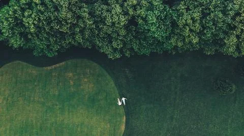 Couple is lying on a golf course Stock Photos
