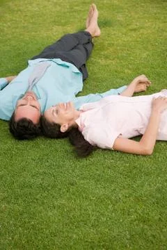 Couple lying on grass Stock Photos