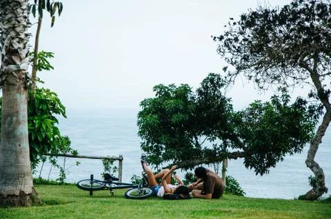 A couple lying on the lawn Stock Photos