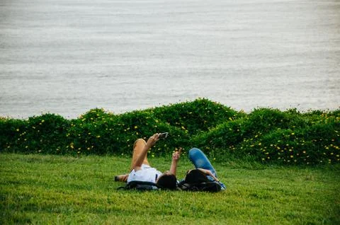 A couple lying on the lawn Stock Photos