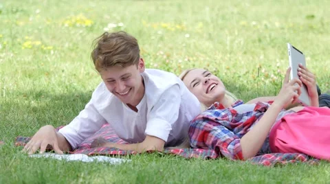 Couple Lying on a Lawn Reading Talking Students Girl and Boy Are Preparing to 動画素材 64812868