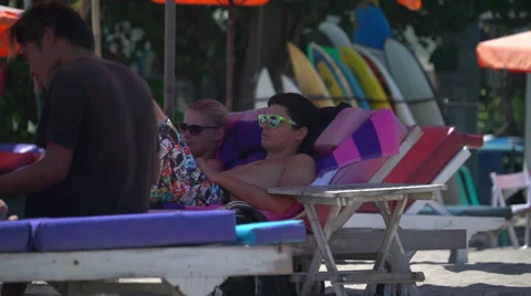 Couple Lying in Shade on Beach Stock Footage 49408242