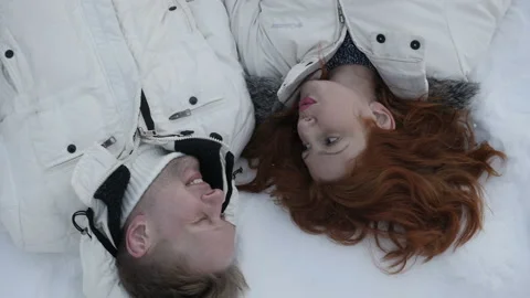 Couple lying on snow Stock Footage 87359880