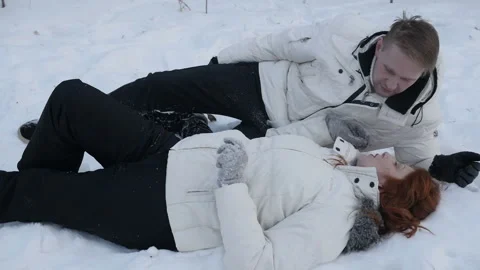 Couple lying in snow in nature Video stock 87361927