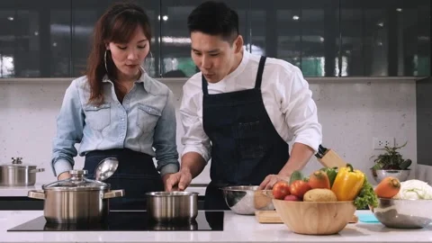 Couple make soup in kitchen. Stock Footage 130800009