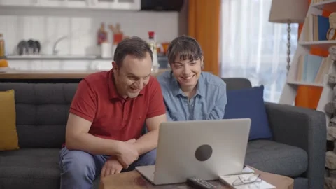 Couple make video calls with their loved ones at their home on the computer. Video stock 148254698