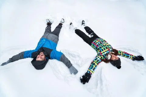 Couple making angles in snow Stock Photos