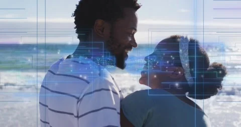 Couple making eye contact sparking smiles sharing affection by ocean blue Stock Footage 334312041