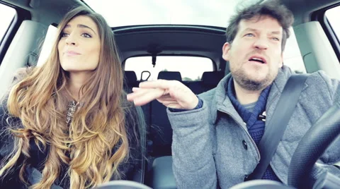 Couple making funny faces while dancing in car slow motion Stock Footage 61930618
