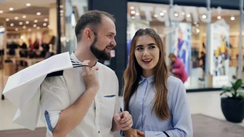 Couple in the mall in front of the showcase Stock Footage 96562559