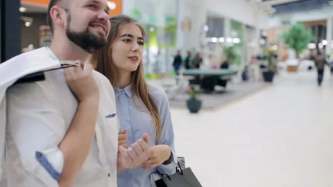 Couple in the mall in front of the showcase Stock Footage 96748949