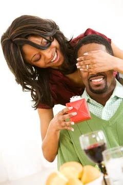 Couple: man getting surprised by gift Stock Photos