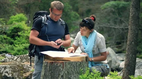 A couple with map and compass in the forest 스톡 동영상 7907522