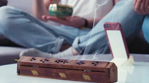 Couple meditating using smartphone video call application. Carrying mental Stock Footage 153057203