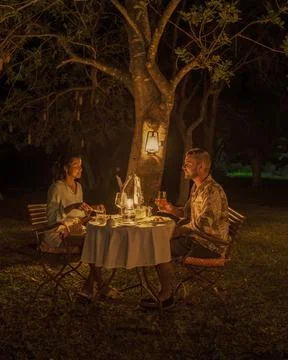 Couple men and woman on a romantic dinner on a luxury safary,South Africa Stock Photos