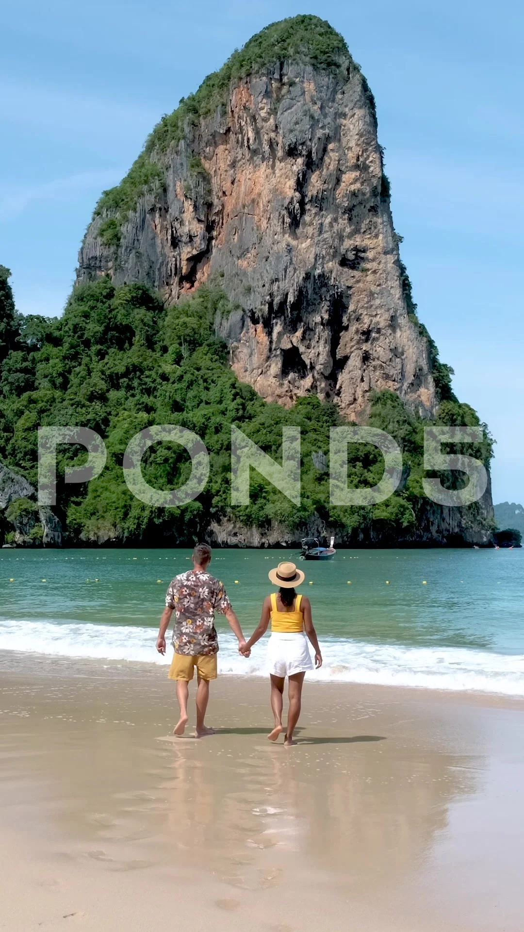 Railay Beach Krabi Thailand, a couple of men and woman on the