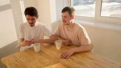Couple of men are sitting at the table with smartphones Stock Footage 144489603