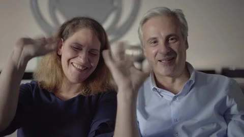 Couple of middle aged parents talking to adult children Stock Footage 101370864