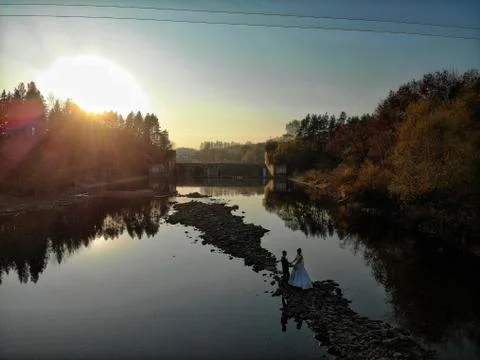 A couple in the middle of the river at sunset Stock Photos