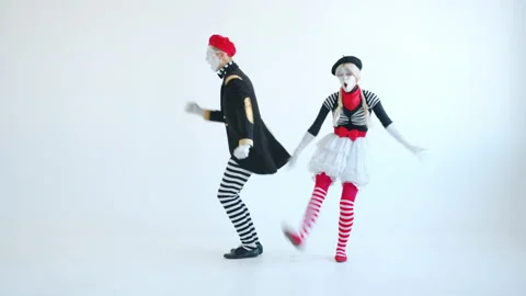 Couple of mimes in bright suits dancing and having fun together on white Stock Footage 144409088