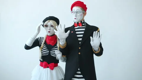 Couple of mimes touching imaginary wall looking for escape then opening Stock Footage 144398611