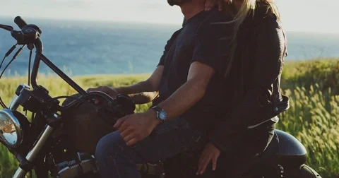 Couple on Motorcycle Watching the Sunset Stock Footage 84231577