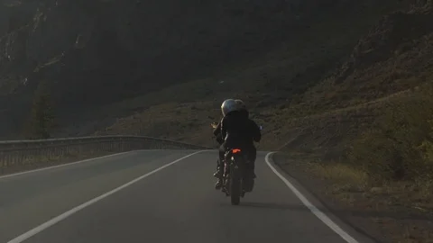 Couple of Motorcyclists are Driving along a Beautiful Mountain Country Road Stock Footage