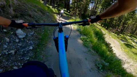 Couple mountain biking in summer. Point of view from action camera.  Stock Footage 201191983