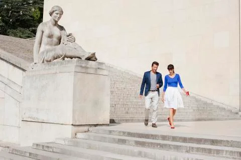 Couple moving down steps, Paris, Ile-de-France, France Stock Photos