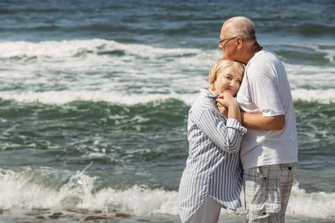 A couple of nice old people. The man holds the woman's hands. she puts her .. Stock Photos