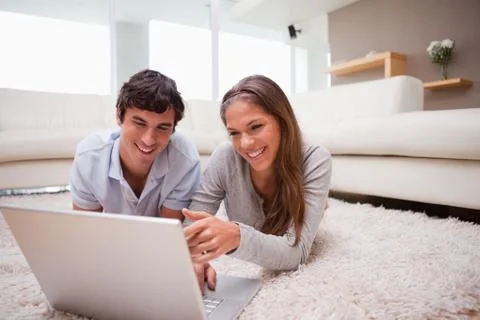Couple with notebook on the floor Stock Photos