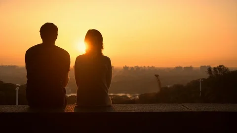 Couple observing the sundown Stock Footage 113464071