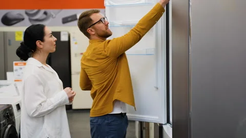 Couple open door of the refrigerator in the hardware electronics store and Stock Footage 279593404