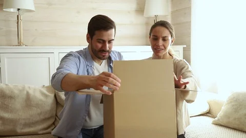 Couple open parcel feels dissatisfied with damaged broken goods inside Stock Footage 114924272