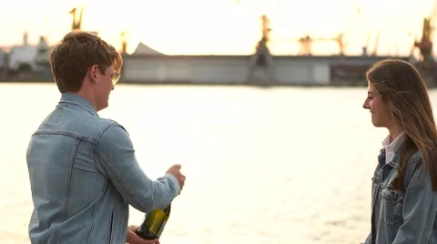 Couple opens the champagne on the background of the port Stock Footage 68440288