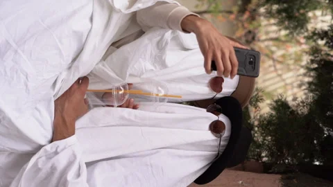 Couple or friends using trendy entertainment is to dress in white bedspreads or Stock Footage 243423565