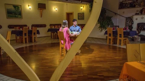 Couple out on date fine dining, Alone in a nice restaurant with wooden Stock Footage 123799717