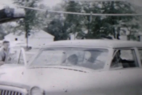 Couple packing up car and Pulling Out of Driveway Stock Footage 24700497