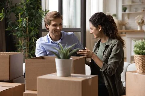 Couple packing their belongings preparing for relocation to new house Stock Photos