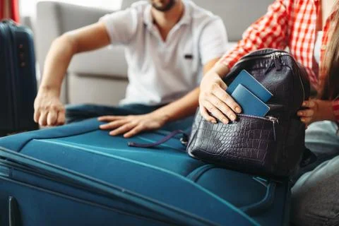 Couple packing their suitcases and take documents Stock-Fotos