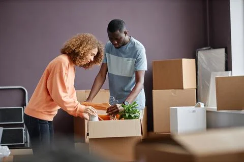 Couple packing things for relocation Stock Photos