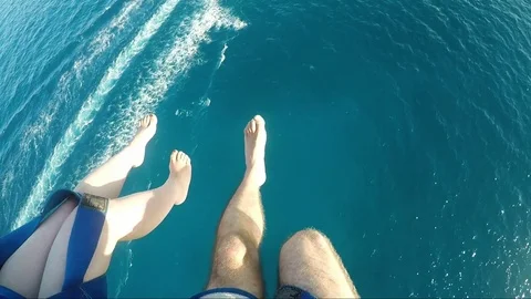 Couple Parasailing Over The Sea Stock Footage