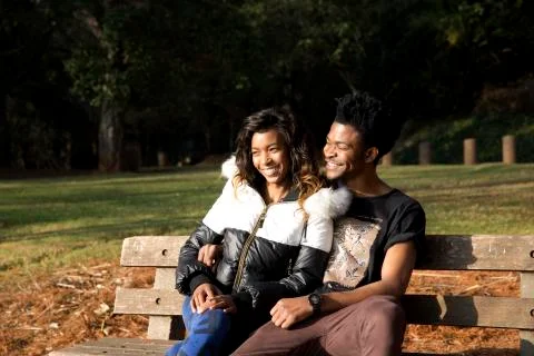 Couple on a park bench Stock Photos