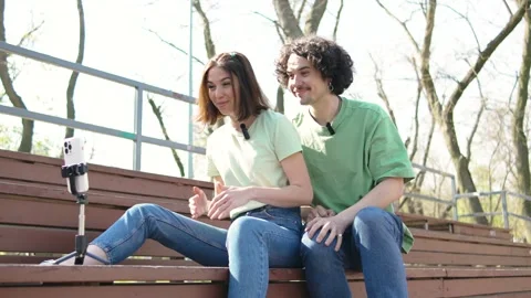Couple at park using a tripod and lavalier microphone to make content for a Stock Footage 277129344