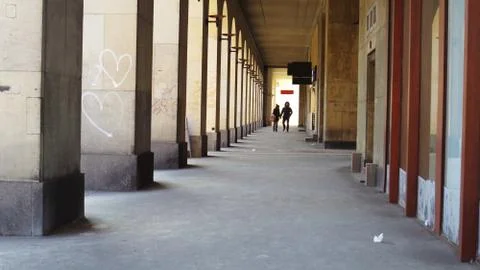 Couple in Passage of Columns Stock Photos