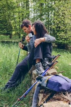 Couple pausing while doing trekking Stock Photos