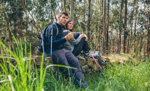 Couple pausing while doing trekking Stock Photos